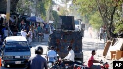 An armored police car patrols the streets in Port-au-Prince, Haiti, Jan. 26, 2024. Haiti's government on Jan. 29 announced a crackdown on a state environmental department whose heavily armed agents were blamed for violent clashes with police last week. 