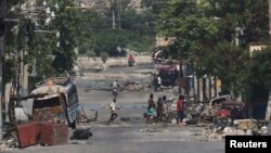 FILE - Armed gang members walk through the streets in Port-au-Prince, Haiti, April 23, 2024. 