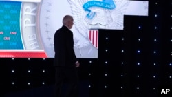 FILE - President Joe Biden walks off stage during the break at a presidential debate with Republican presidential candidate former President Donald Trump, in Atlanta, June 27, 2024. 