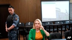 FILE - Marina Ovsyannikova, a former Russian state TV journalist who quit after making an on-air protest of Russia's military operation in Ukraine, sits in a court room prior to a hearing in Moscow, July 28, 2022.