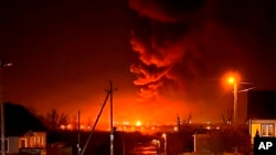 FILE - In this photo taken by an anonymous source, oil storage facilities burn in Bryansk, Russia, April 25, 2022. 