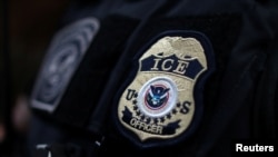 FILE - The badge of a field office director for the U.S. Immigration and Customs Enforcement's Enforcement and Removal Operations in Hawthorne, California, on March 1, 2020.