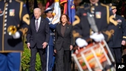 President Joe Biden, left, and Vice President Kamala Harris arrive at a wreath laying ceremony at the Tomb of the Unknown Soldier during a Veterans Day observance at Arlington National Cemetery in Arlington, Virginia, Nov. 11, 2024.