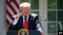 President Donald Trump speaks about the U.S. role in the Paris climate change accord, June 1, 2017, in the Rose Garden of the White House in Washington. 