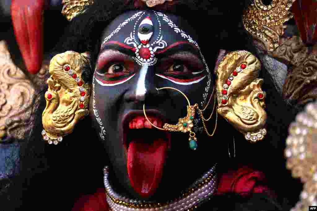 A devotee dressed as the Hindu deity Maha Kali performs during Navratri festival celebrations in Ajmer, Rajasthan state, India.