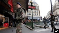 French soldiers patrol in the street near a department store in Paris as part of the highest level of "Vigipirate" security plan in Paris January 10, 2015.