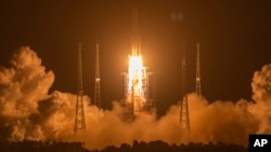 FILE - In this Nov. 24, 2020, photo, a Long March-5 rocket carrying the Chang'e 5 lunar mission lifts off at the Wenchang Space Launch Center in Wenchang in southern China's Hainan Province.