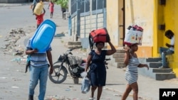 People flee their neighborhood after armed gangs terrorized the Delmas 24 and Solino areas, in Port-au-Prince, Haiti, Oct. 20, 2024. 