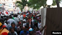 Haitians stand outside the Ministry of Interior and Police while waiting to register in the so-called "regularization" program, in Santo Domingo, June 17, 2015. 