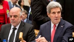 Ngoại trưởng Hoa Kỳ John Kerry (phải) trong phiên họp cấp cao về chiến dịch chống nhóm Nhà nước Hồi giáo tại Brussels, 3/12/14