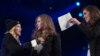 Madonna (L) introduces Russian punk rock band Pussy Riot members Nadezhda Tolokonnikova (R) and Maria Alyokhina during the Amnesty International benefit concert in the Brooklyn borough of New York February 5, 2014. REUTERS/Carlo Allegri (UNITED STATES - T