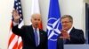 U.S. Vice President Joe Biden (L) waves as he meets Polish President Bronislaw Komorowski in Warsaw March 18, 2014.