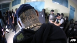 Handout photo released by Guatemala's Interior Ministry showing a Mara 18 gang member during a raid at Fraijanes II prison in Guatemala City on May 26, 2024.