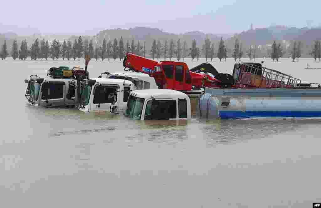 Trucks and vehicles are seen in floodwaters from heavy rains caused by Typhoon Mitag in Gangneung, South Korea.