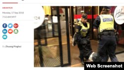 Cảnh sát Thụy Điển mang người đàn ông Trung Quốc ra khỏi khách sạn ở Stockholm. Photo The Star Online.