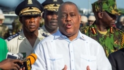 Haitian Prime Minister Garry Conille, with Chief of Police Normil Rameau (L), speaks during a ceremony as Haitian government officials visit the Kenyan police force at their base in the Clercine neighborhood of Port-au-Prince on June 26, 2024.