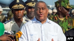 Haitian Prime Minister Garry Conille, with Chief of Police Normil Rameau (L), speaks during a ceremony as Haitian government officials visit the Kenyan police force at their base in the Clercine neighborhood of Port-au-Prince on June 26, 2024.