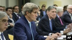 Ngoại trưởng Hoa Kỳ John Kerry (thứ hai từ trái sang) và Bộ trưởng Năng lượng Hoa Kỳ Ernest Moniz (trái) tại cuộc họp về chương trình hạt nhân Iran với các giới chức từ Pháp, Trung Quốc, EU, và Iran ở Lausanne, Thụy Sĩ, 31/3/2015.