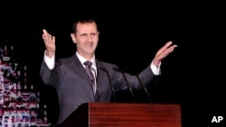 Tổng thống Syria Bashar al-Assad đọc diễn văn đầu tiên kể từ tháng 6 tại nhà hát lớn ở trung tâm thủ đô Damascus, ngày 6/1/2013.