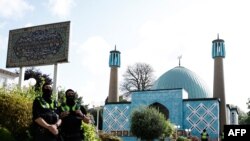 Police officers are seen in front of the "Blue Mosque", housing the Islamic Centre of Hamburg, northern Germany, on July 24, 2024, after a ban by German Interior Ministry following several months of investigation over its alleged support for Lebanon's Hez