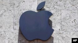 FILE - The Apple logo is seen at a store in Miami Beach, Florida, Aug. 8, 2017. 