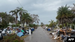 Debris from Hurricane Helene lines a street in the Redington Beach section of St. Petersburg, Florida, on October 8, 2024, ahead of Hurricane Milton's expected landfall.