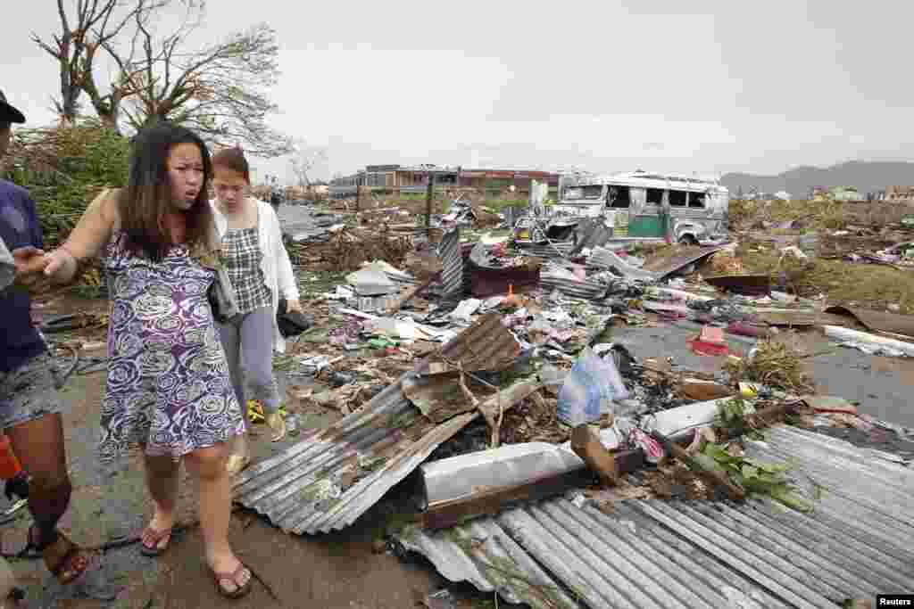 Một phụ nữ mang thai đi qua đống đổ nát sau&nbsp;Siêu bão Haiyan tại thành phố Tacloban, miền trung Philippines, ngày 9/11/2013.