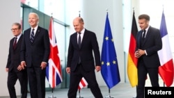 German Chancellor Olaf Scholz, U.S. President Joe Biden, Britain's Prime Minister Keir Starmer and French President Emmanuel Macron prepare to pose for a family photo session, at the Chancellery in Berlin, Germany, Oct. 18, 2024. 